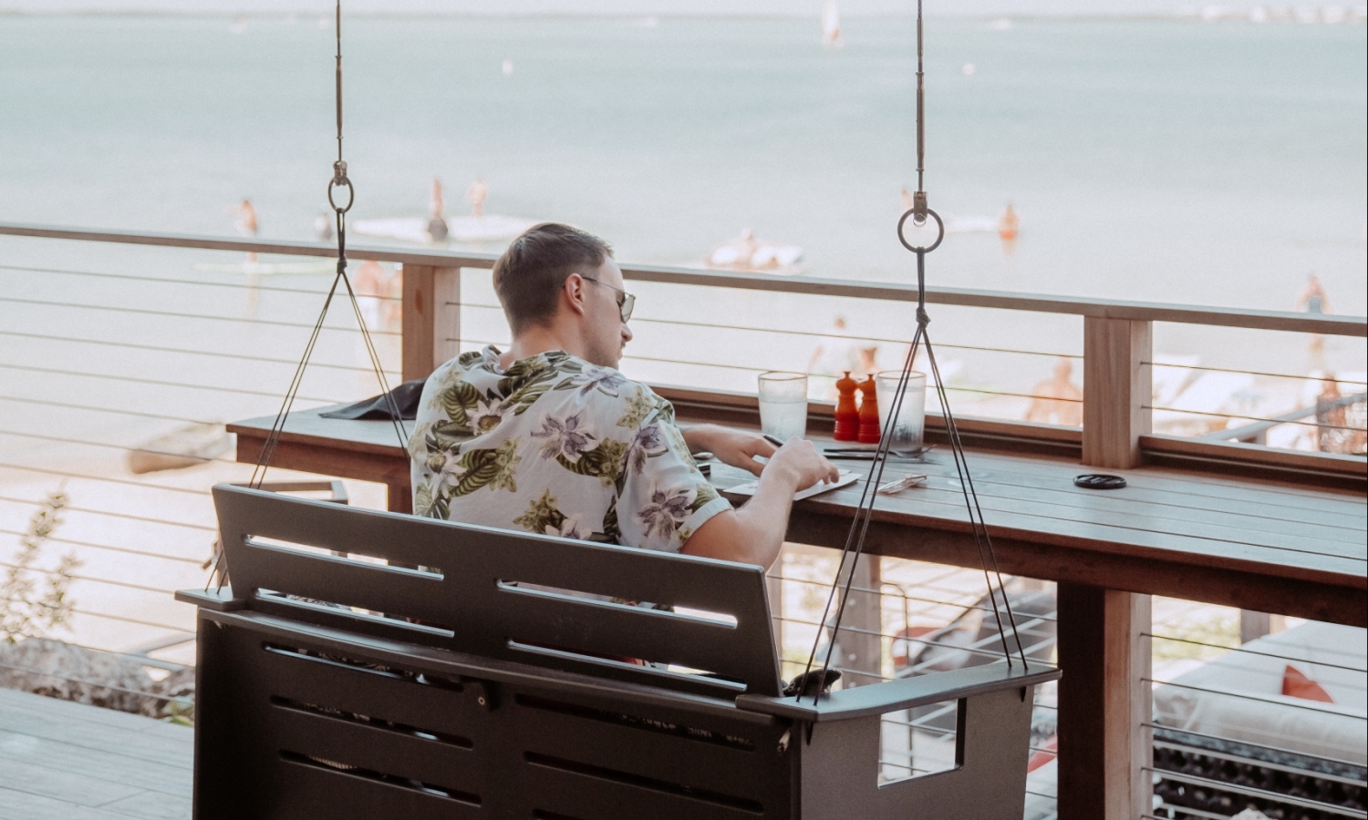 a man sitting outside writing on a pad