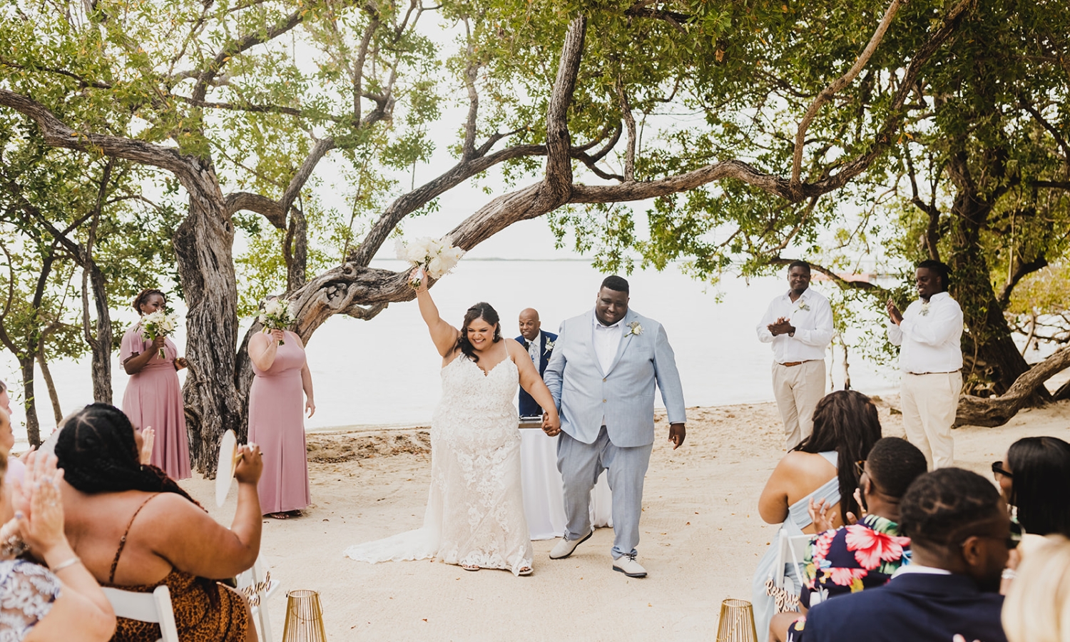 a bride and groom holding hands after their wedding ceremony