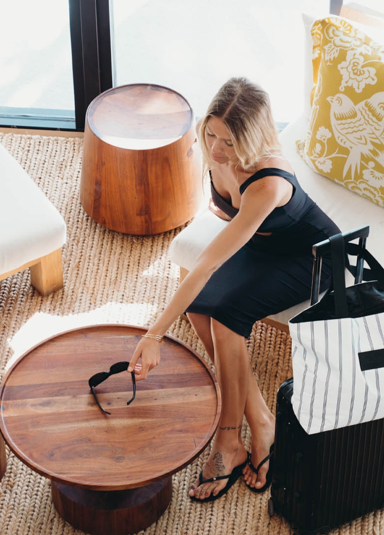 a woman placing her sunglasses on a table