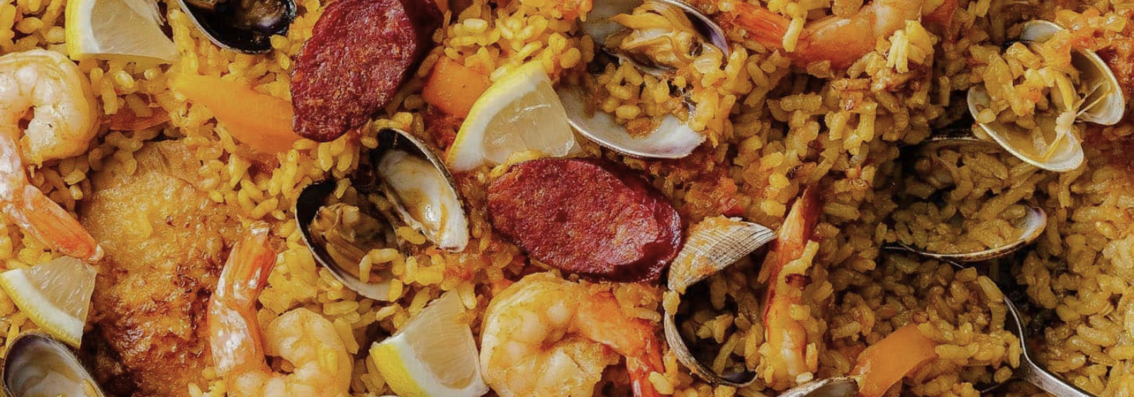Paella rice with clams and shrimps on a plate