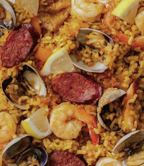 Paella rice with clams and shrimps on a plate