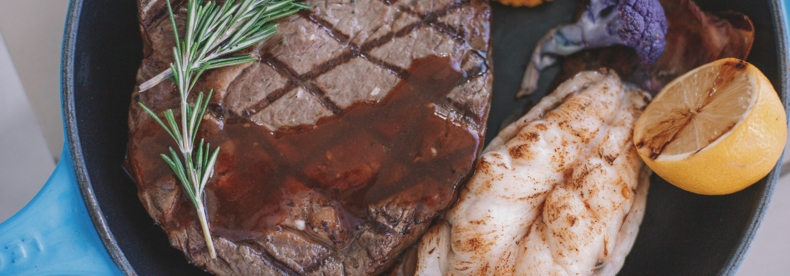 Prime rib and lobster on a plate