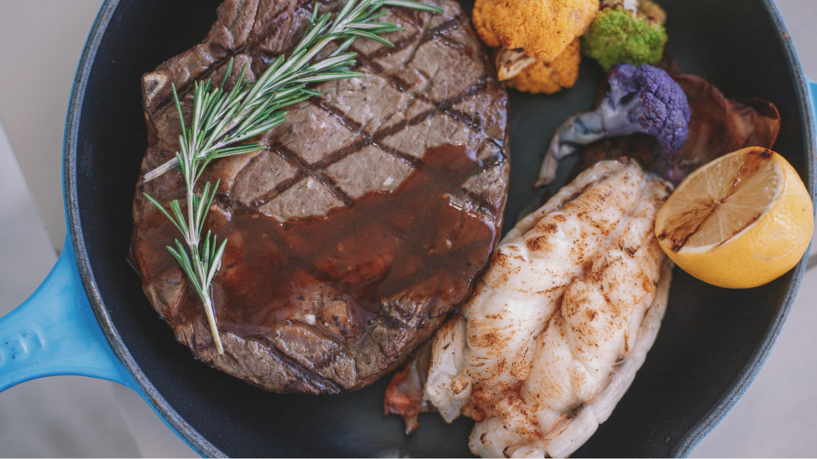 Prime rib and lobster on a plate
