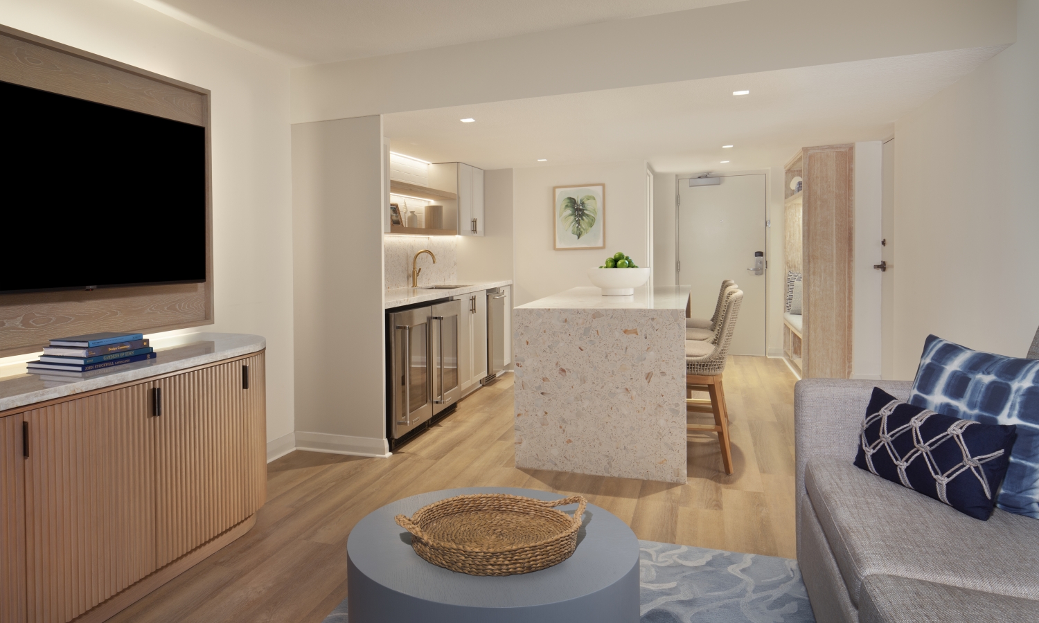 suite living space with tv and kitchen