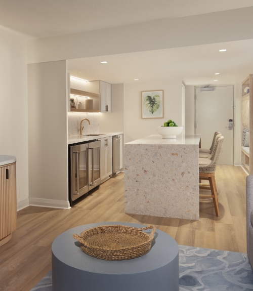 suite living space with tv and kitchen